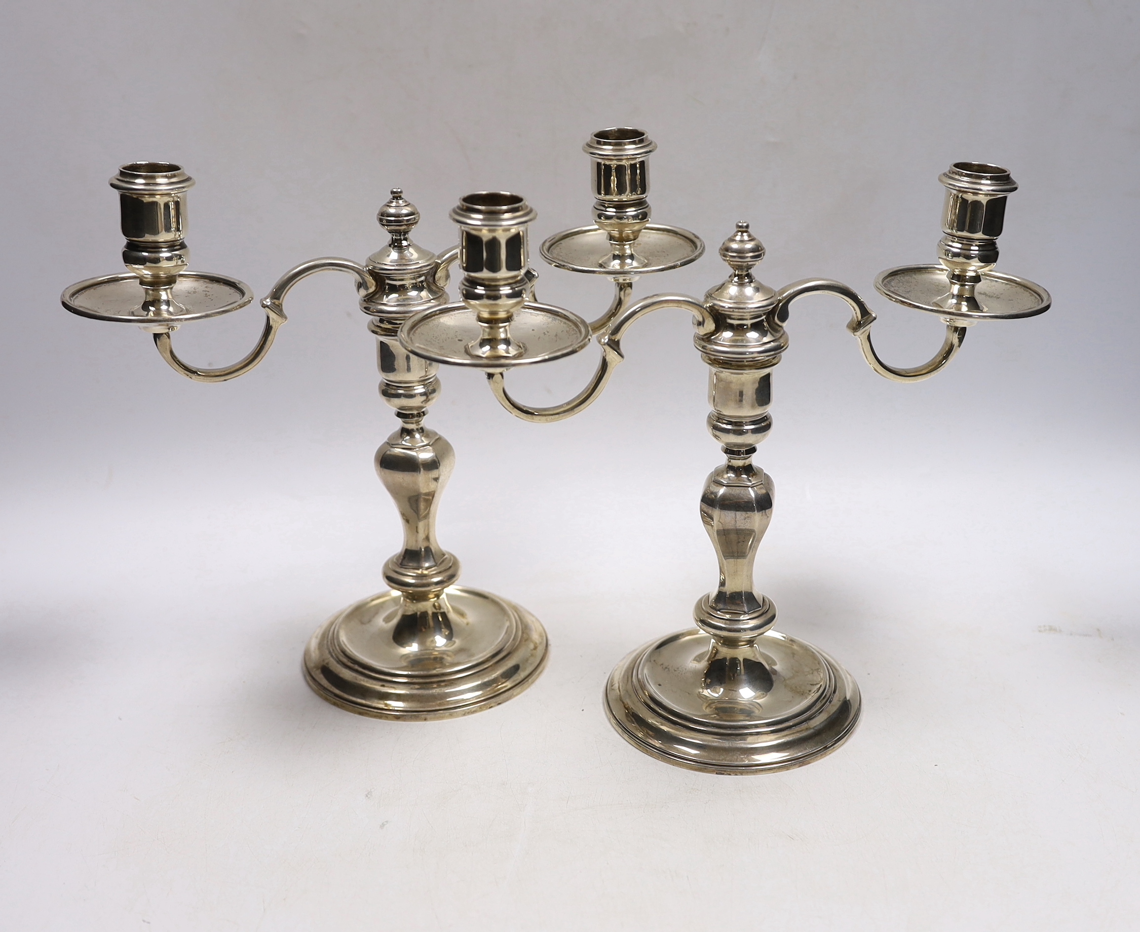 A pair of George VI silver two branch, two light candelabra, Thomas Ducrow & Sons, Birmingham, 1945, height 20.8cm, 44.6oz.